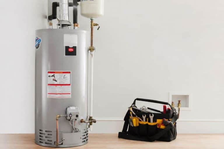 Residential gas water heater with plumbing tools during Water Heater Installations in Boerne, TX.